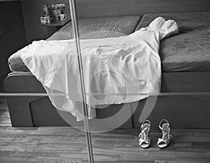Wedding dress with shoes in mirror