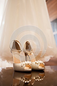 Wedding dress and shoes in a room