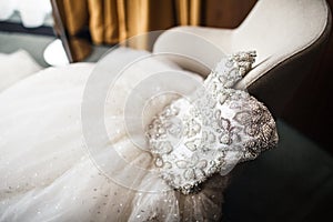 Wedding dress on the vintage chair, close-up