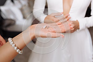 Wedding earrings on a female hand wear, she takes the earrings, the bride fees, morning bride, woman in white dress