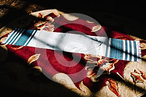 Wedding embroidered towel. Fortunately. To share. Fate. The towel is lying on the floor pad in the room. Wedding day. Close up.