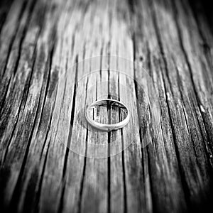 Wedding or engagement ring on wood