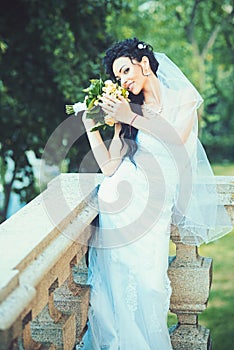 Wedding fashion and vogue. Sensual woman with wedding bouquet. Woman with flowers on balcony. Beauty girl with bridal