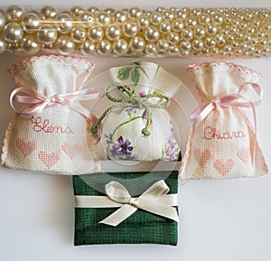 Wedding favor bags containing sugar-coated almonds , dates gift