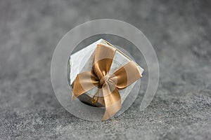 Wedding favor, decorated with fabric and golden ribbon, for guest gifts at various events