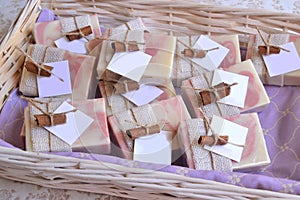 Wedding favors decoration white wicker basket with handmade soaps guest gifts jute and cinnamon details