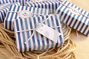 Wedding favours nautical style decoration soap guest gifts, wrapped in blue white striped pattern papersailor rope