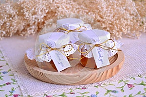 Wedding favours orange jam in small glass jars with white doily thank you custom guest gift