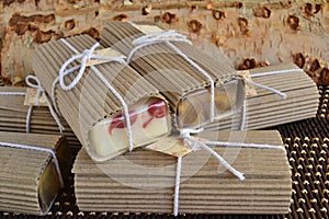 Wedding favours wrapped soaps guest gifts in brown colour craft cardboard paper and white ribbon