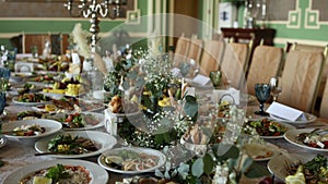 Wedding festive table with food, decor and flowers in a restaurant