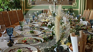 Wedding festive table with food, decor and flowers in a restaurant