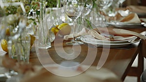 wedding festive table set with plates with peach down napkins and fresh flowers