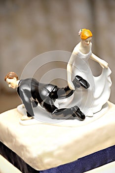 Wedding figurine with bride dragging the groom photo