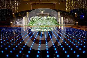 Wedding floral decoration with candles and blue dance floor