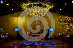 Wedding floral decoration with candles and blue dance floor