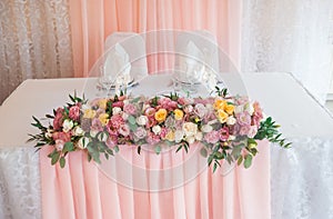 Wedding floristics. Decoration of a table fresh flowers. Wedding in pink color