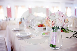 Wedding floristry. Beautiful lush bouquet on the table in restaurant