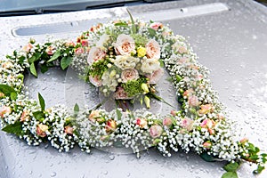 Wedding flower bouquet in hearth shape on car bonnet