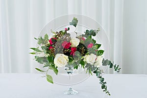 Wedding flower composition on table. Bouquet with roses with number three
