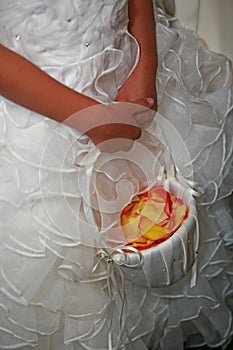 Wedding flower girl holding flower basket