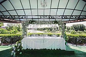 Wedding flower table decoration with candles on a green background of nature