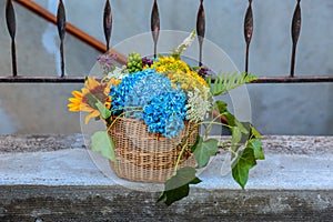 Wedding flowers basket basket standing on a porch of a house