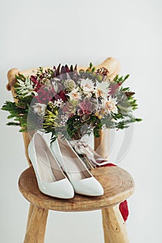 Wedding flowers bouqete with shoes on the chair