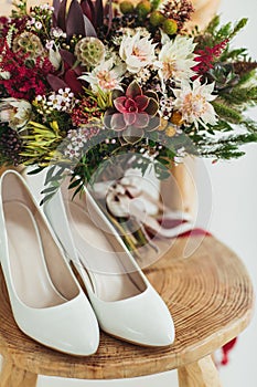 Wedding flowers bouqete with shoes on the chair