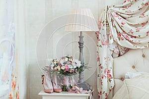 Wedding flowers bouqete with shoes on the nightstand