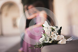 Wedding flowers bouquet with newlywed couple on background