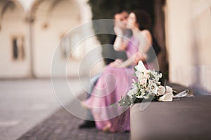 Wedding flowers bouquet with newlywed couple on background