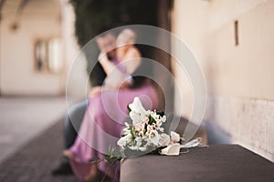 Wedding flowers bouquet with newlywed couple on background