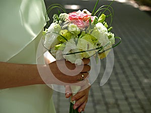 Wedding flowers. Bride in bridal beige dress holds wedding bouquet