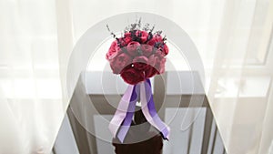Wedding flowers - bride`s bouquet at mirror table