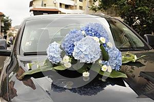 Wedding flowers on a expensive car