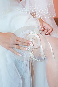 Wedding garter on the bride`s leg