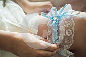 Wedding garter on the bride`s leg