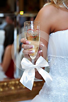 Wedding glass of champagne in hand bride