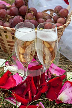 Wedding glasses of champagne on background basket with grapes