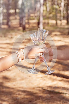 Wedding glasses with champagne in couple`s hands