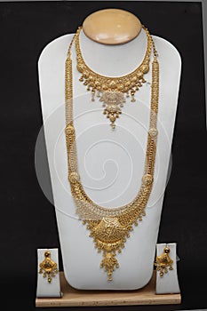 wedding gold combo necklace with earrings of Indian subcontinents on white background.