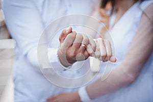 Wedding gold rings on the hands of the newlyweds. Gold rings on the hand of a man and a woman