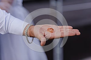 Wedding gold rings on the hands of the newlyweds. Gold rings on the hand of a man and a woman