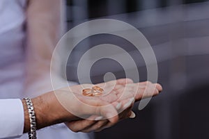 Wedding gold rings on the hands of the newlyweds. Gold rings on the hand of a man and a woman