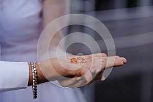 Wedding gold rings on the hands of the newlyweds. Gold rings on the hand of a man and a woman