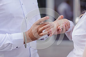 Wedding gold rings on the hands of the newlyweds. Gold rings on the hand of a man and a woman