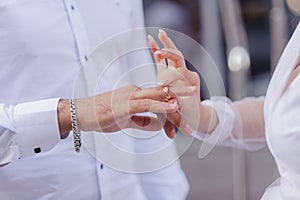 Wedding gold rings on the hands of the newlyweds. Gold rings on the hand of a man and a woman