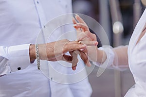 Wedding gold rings on the hands of the newlyweds. Gold rings on the hand of a man and a woman