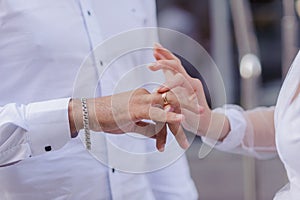 Wedding gold rings on the hands of the newlyweds. Gold rings on the hand of a man and a woman