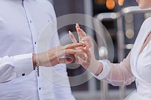 Wedding gold rings on the hands of the newlyweds. Gold rings on the hand of a man and a woman